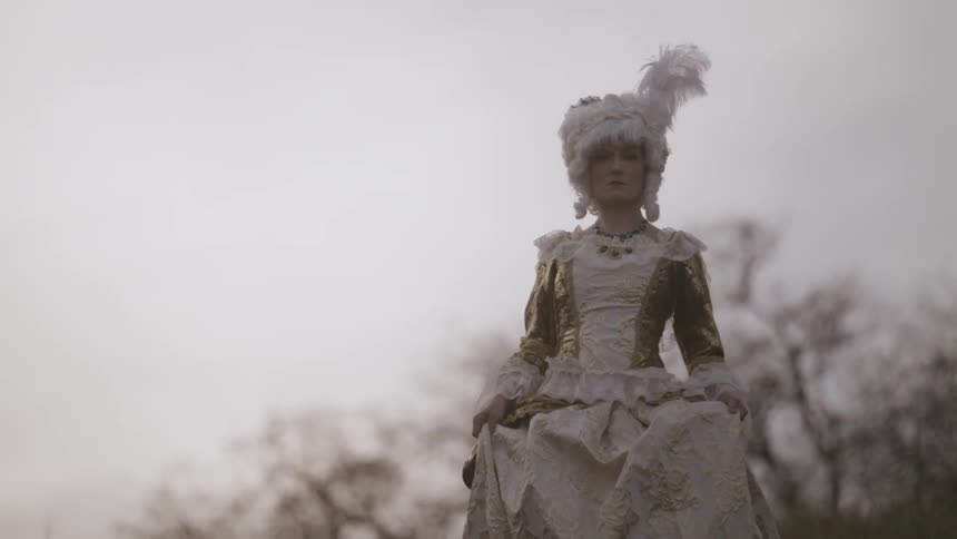 Woman walking in an old fashioned dress outside