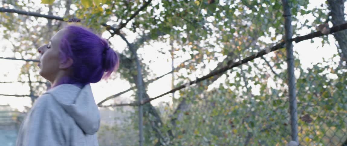 Woman hops in a fenced in area