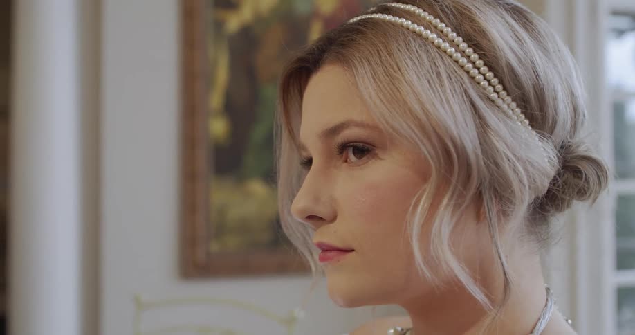 A woman looks around in the bright room