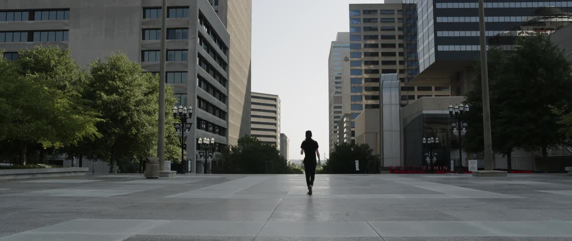 Man dances in the middle of a city square