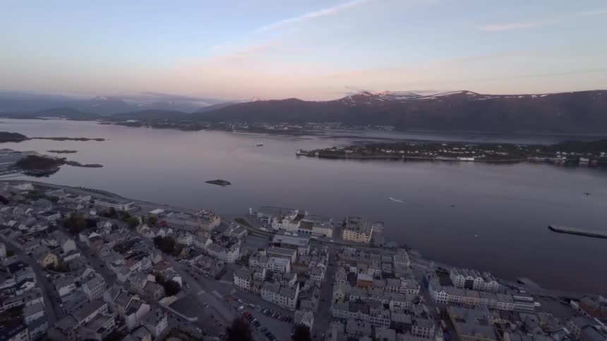 A coastal town is shown from above at dawn