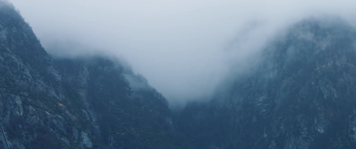 The mountains are covered in thick clouds