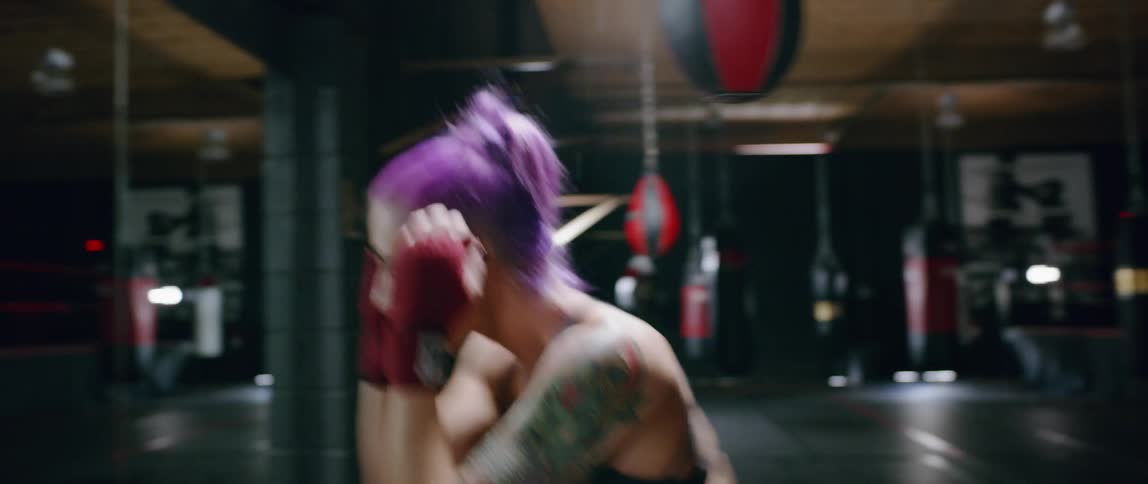 A woman punches in front of the mirror