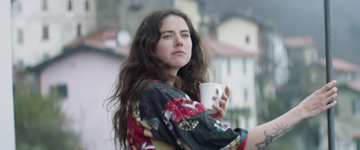Woman standing on balcony in the morning