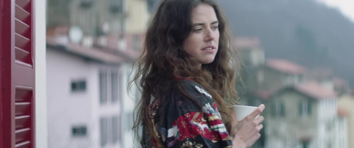 Woman standing on balcony in the morning