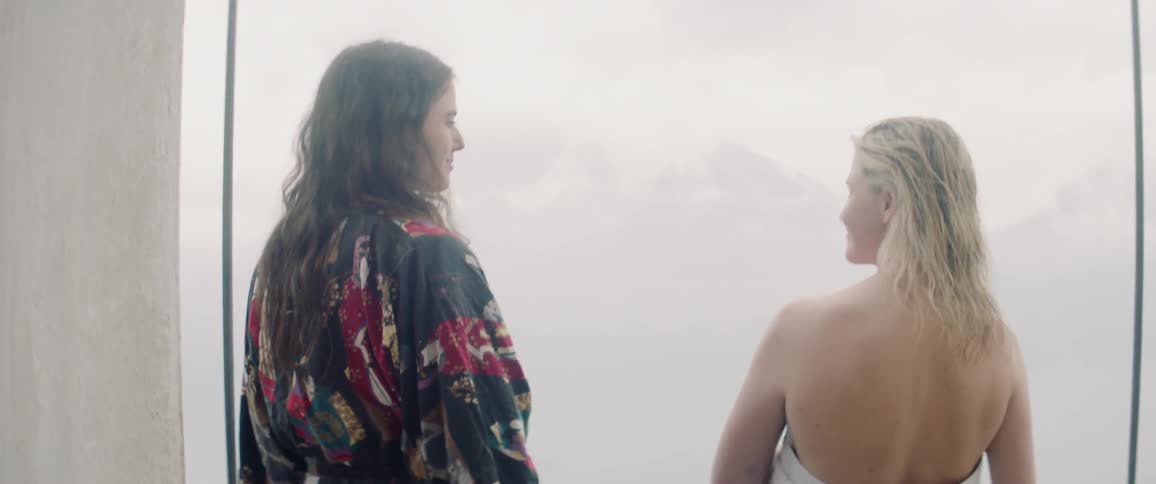 Two women talk together on a foggy day