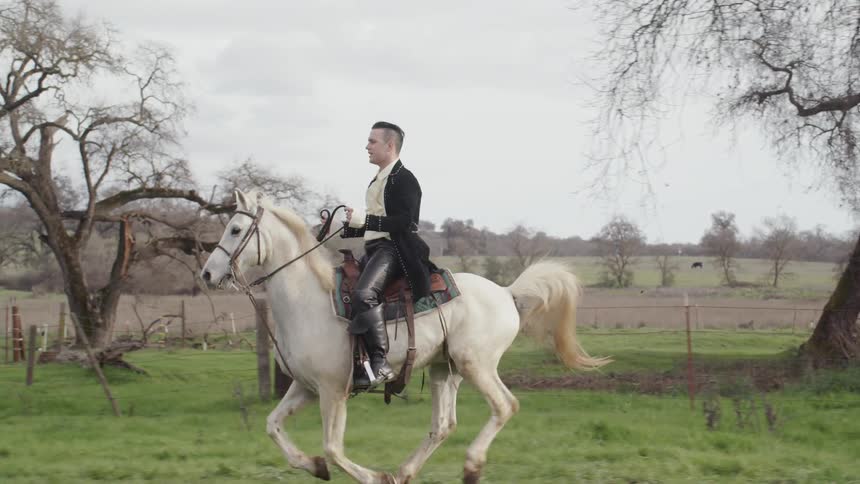 Man in period costume rides horse