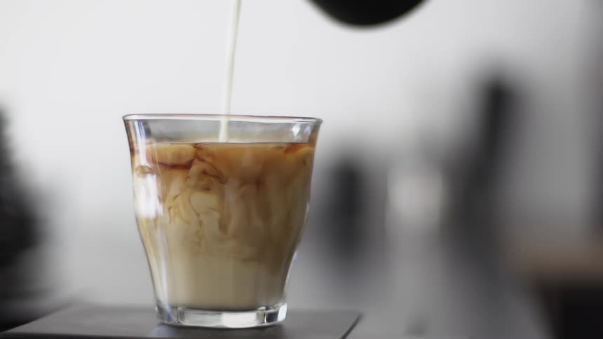 Milk is poured into coffee