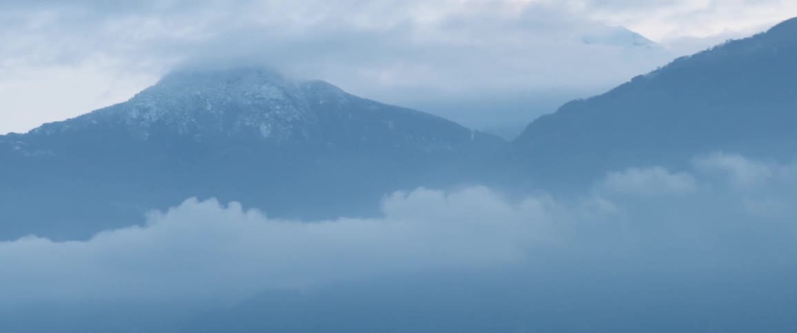 View of mountains through the clouds