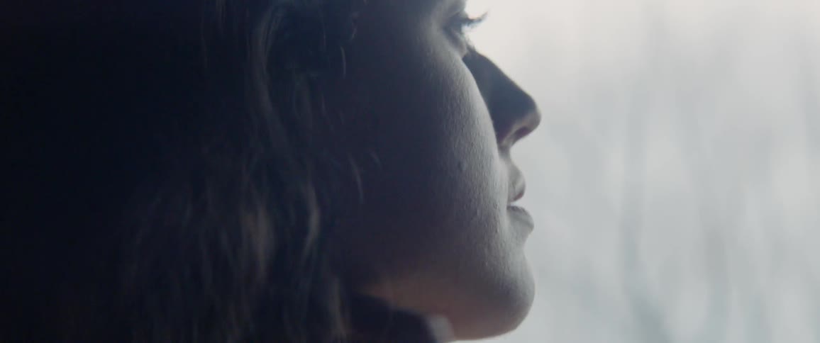A woman stares out the window