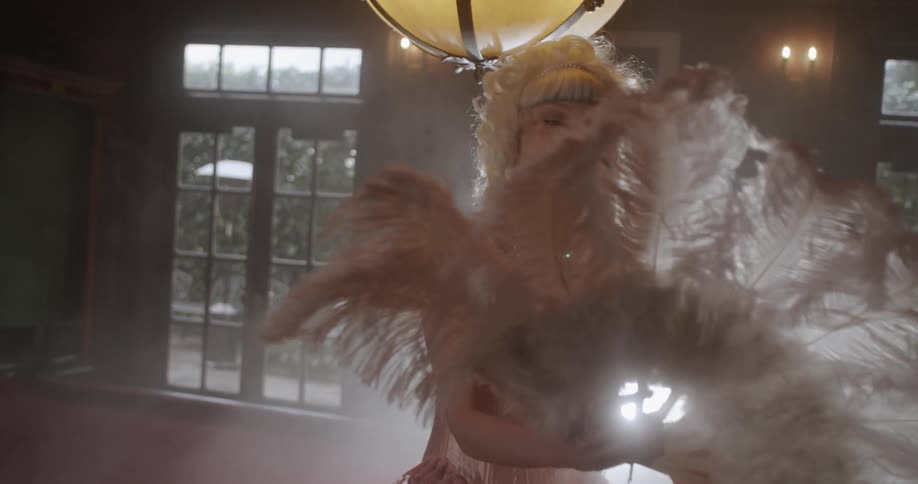 Woman in old fashioned dress dancing inside