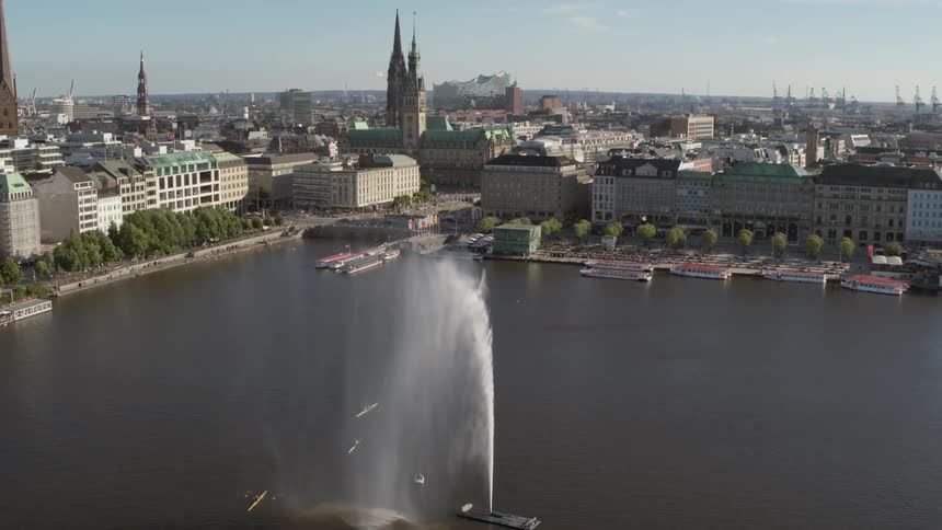 Hamburg Jungfernstieg Fountain in the middle of a lake sprays up tall