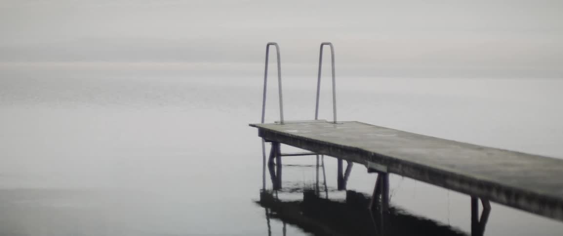 The water flows gently towards the pier