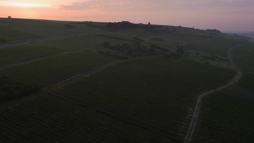 Sunrise over hillside farmland