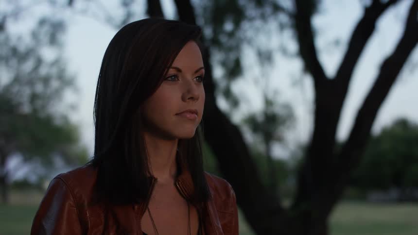 A brunette woman staring into the distance