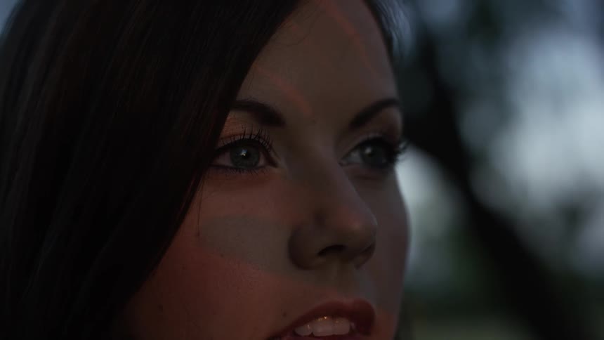 A close up of a brunette woman looking into the distance