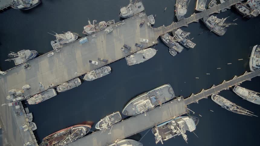 Overhead view of long shadows along harbor and ship docks