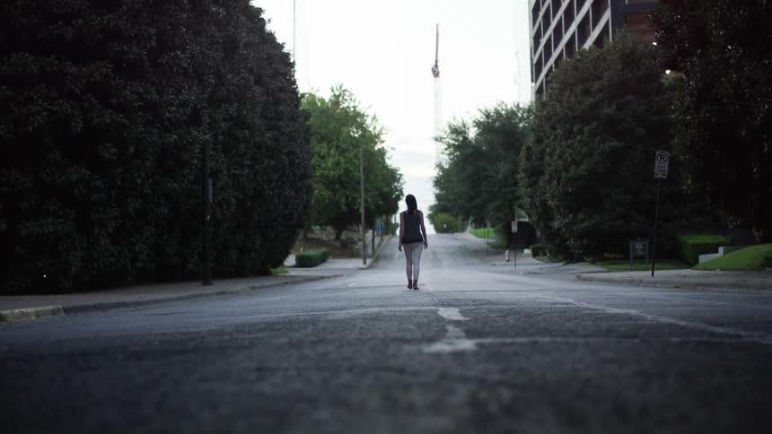 A woman walks down a street