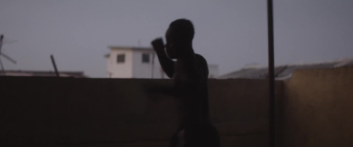 Man on rooftop practices boxing