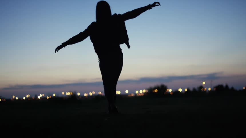 A person walking in the dusk