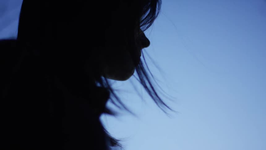 A woman with dark hair staring at something
