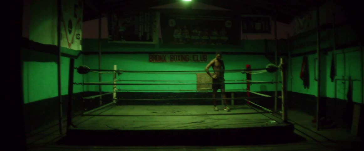 A man walks around the dark ring