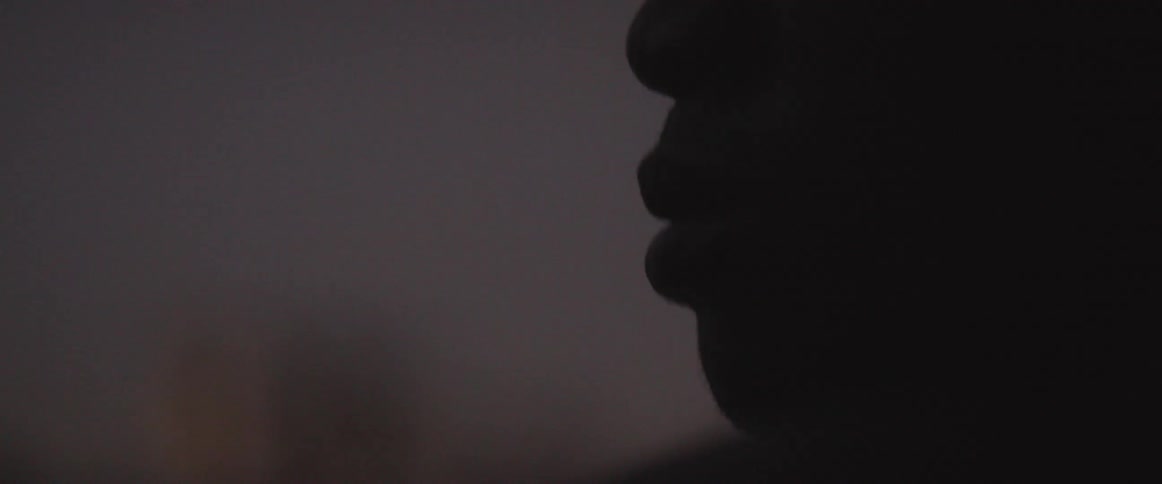 A person stands in the dark