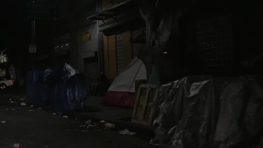 A view of a homeless camp and tents on a city street