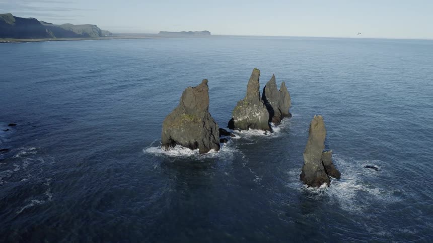 Rock formations stick up from a body of water