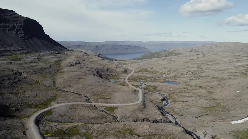 A road winds through a desert landscape