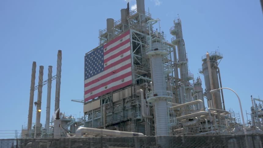 View of a factory that has a large american flag on the side