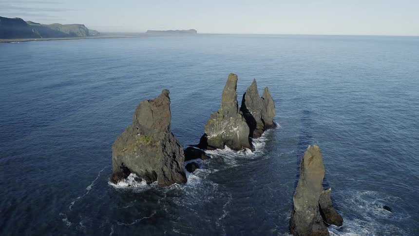 Rock formations stand in an ocean