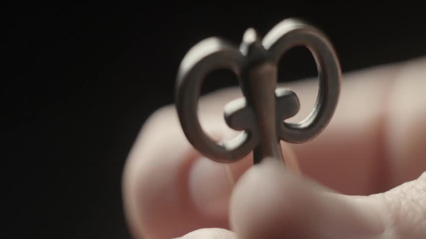 Fingers twist a small key around