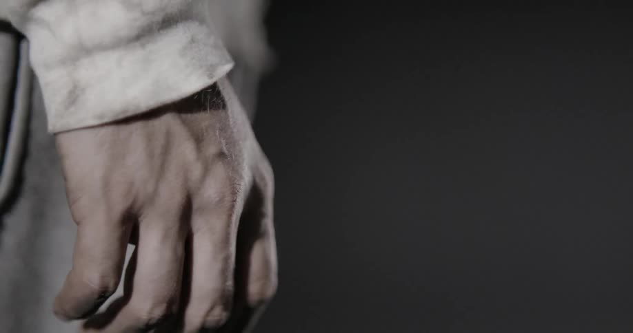 A white light strobes on a mans hand