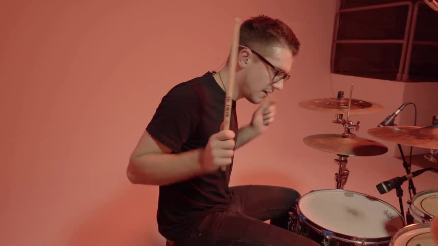 A man is playing the drums