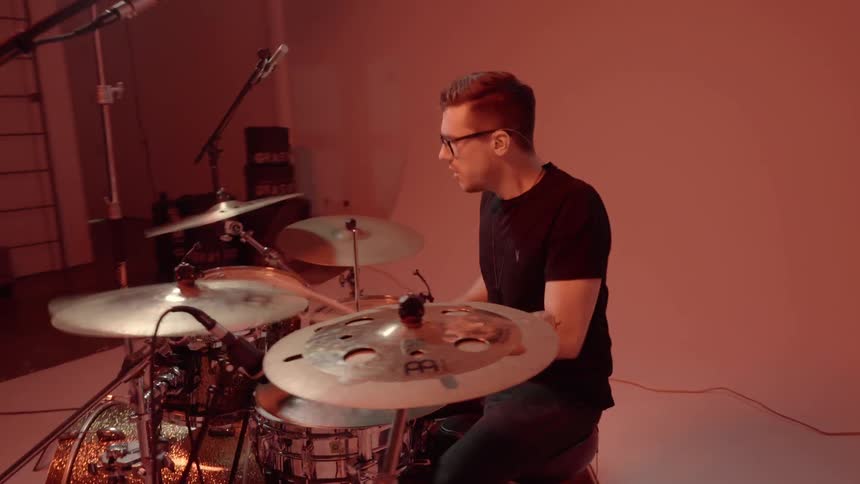 A man is playing the drums fast