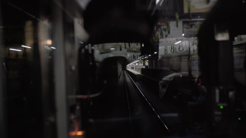 A train drives through a subway station