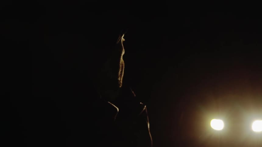 A man on a cell phone outside at night