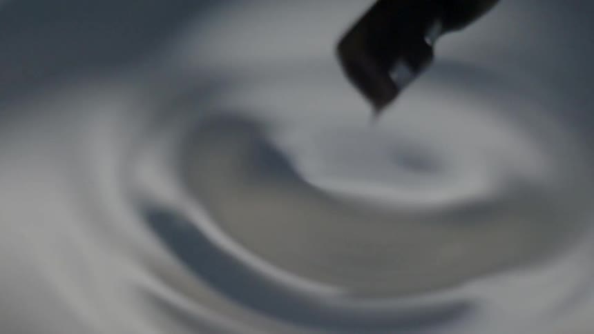 A skeleton key is pulled from the liquid