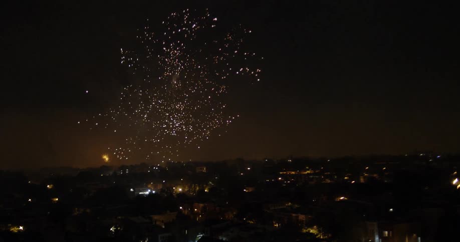 The sky is lit up as fireworks go off