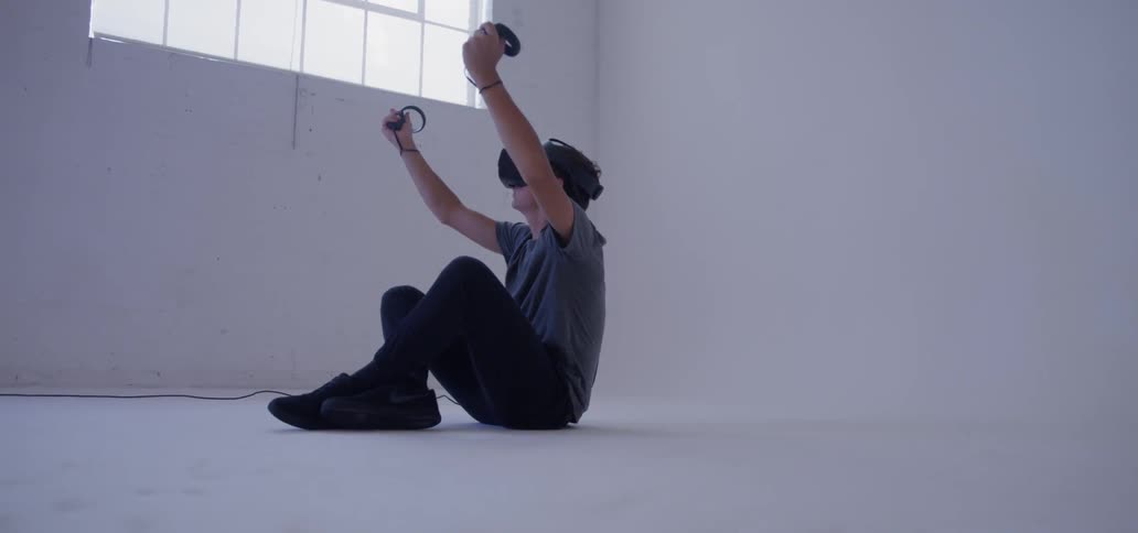 A man uses a vr headset in an empty room