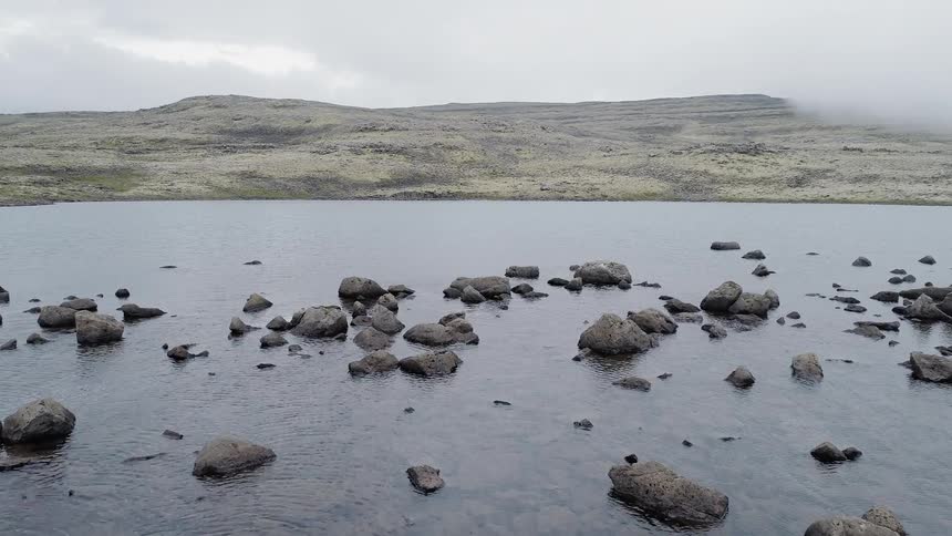 Rocks in a lake near  mountains