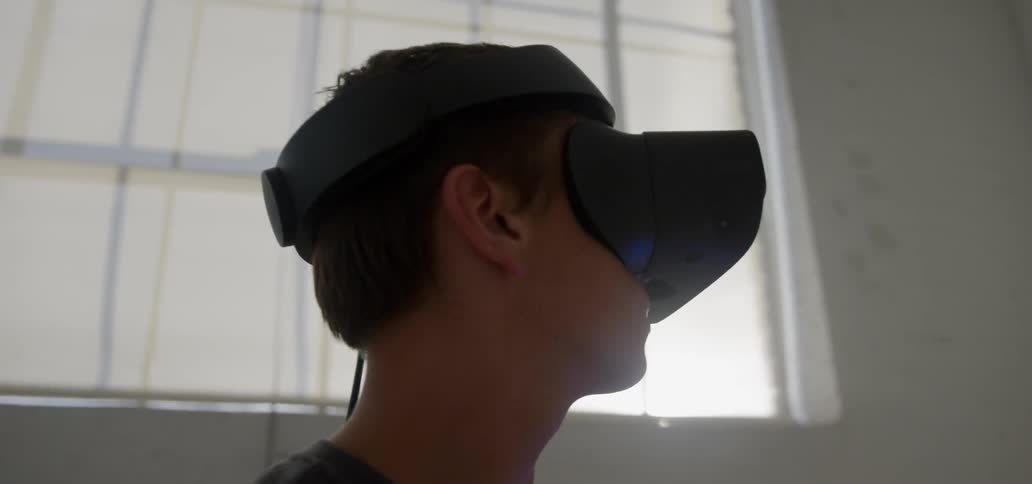 A man is using a virtual reality headset