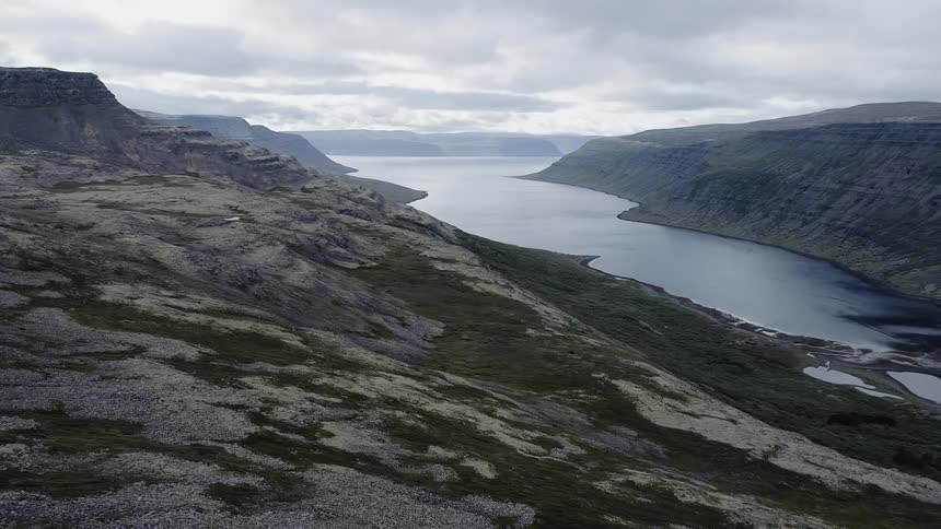 The hills lead down to a lake below