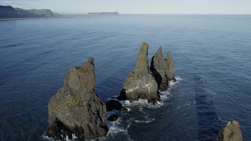 Jagged rocks point out of the deep water