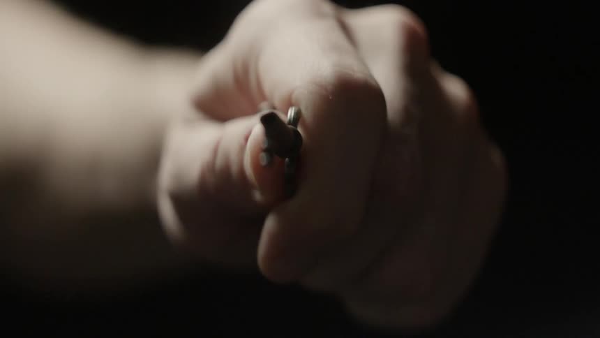 A woman holds an old key in her hand
