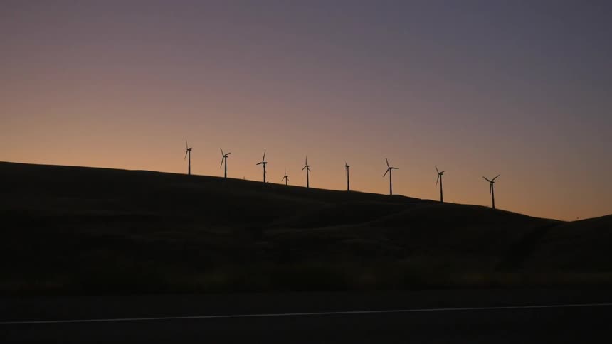 A view of wind generators on a gentle slope