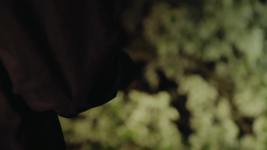A person is searching around with a flashlight