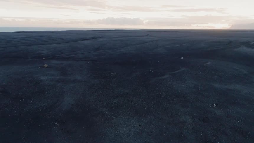 Fuselage of a plane in the middle of a large flat field