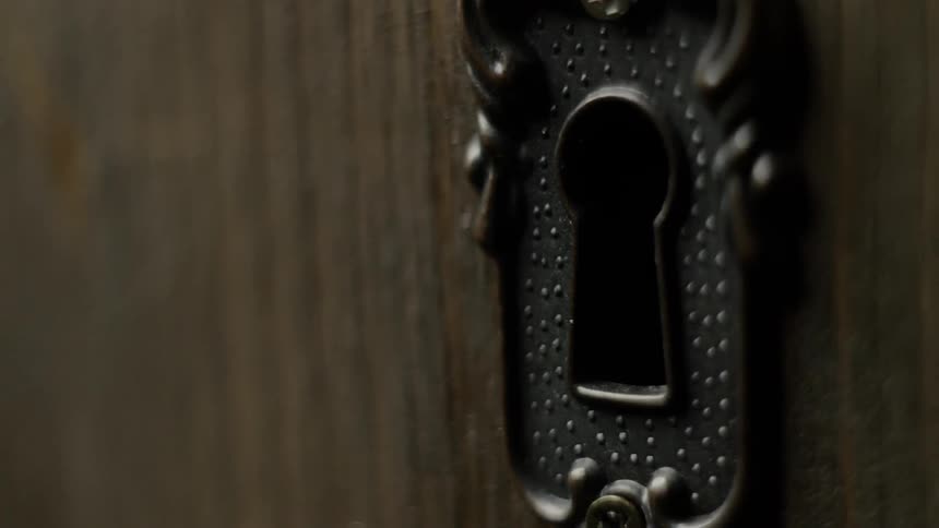 Black keyhole in a door